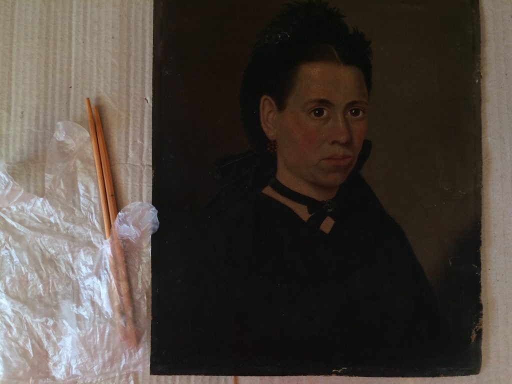  I straightened the card-backed oil painting while cleaning it.